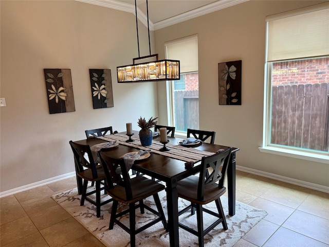 tiled dining space with crown molding, plenty of natural light, and a chandelier