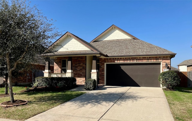 view of front of home featuring a garage, covered porch, and a front yard