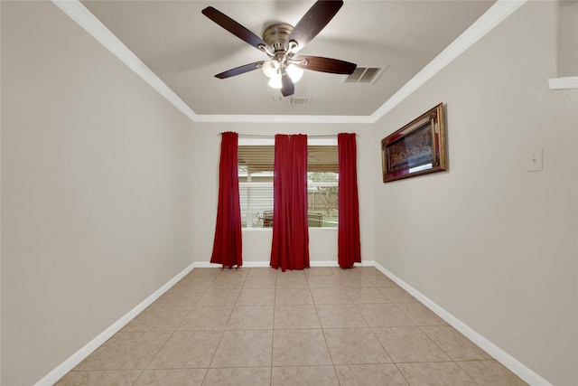 spare room featuring light tile patterned floors, crown molding, and ceiling fan