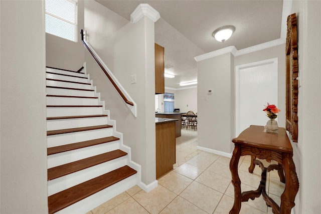 staircase with tile patterned flooring and ornamental molding