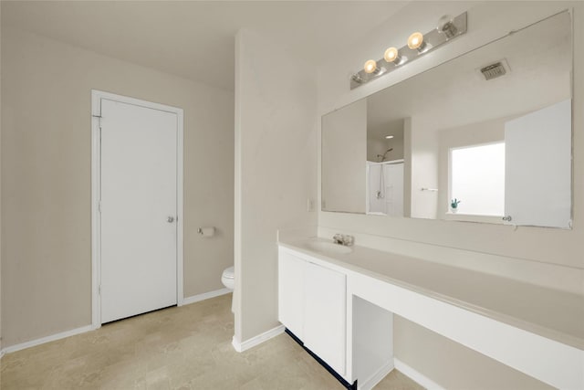 bathroom featuring vanity, walk in shower, and toilet