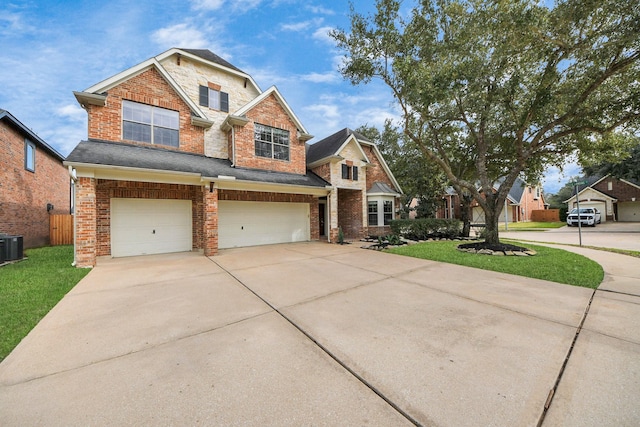 craftsman-style home with brick siding, concrete driveway, an attached garage, fence, and a front yard