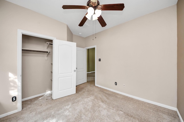 unfurnished bedroom with ceiling fan, a closet, baseboards, and carpet flooring