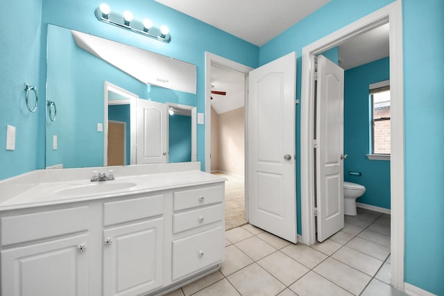 bathroom featuring vanity, tile patterned flooring, toilet, and baseboards