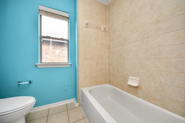 bathroom with toilet, baseboards, and tile patterned floors