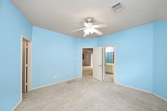 unfurnished bedroom featuring baseboards, visible vents, connected bathroom, and carpet flooring