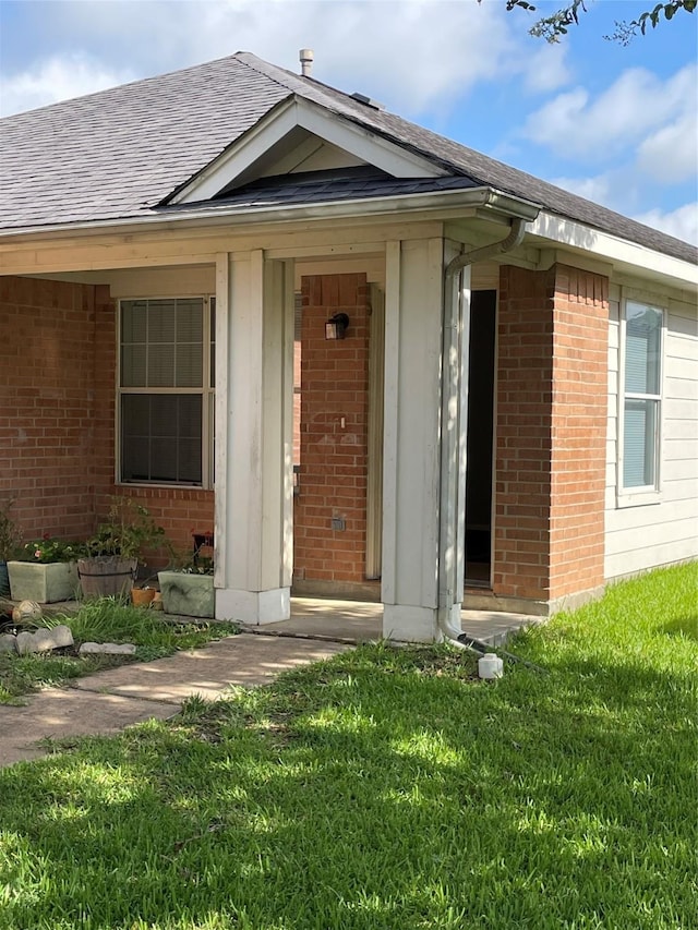 doorway to property with a yard