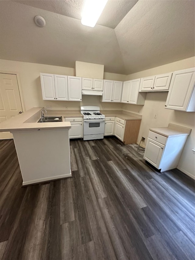 kitchen featuring lofted ceiling, sink, gas range gas stove, and white cabinets