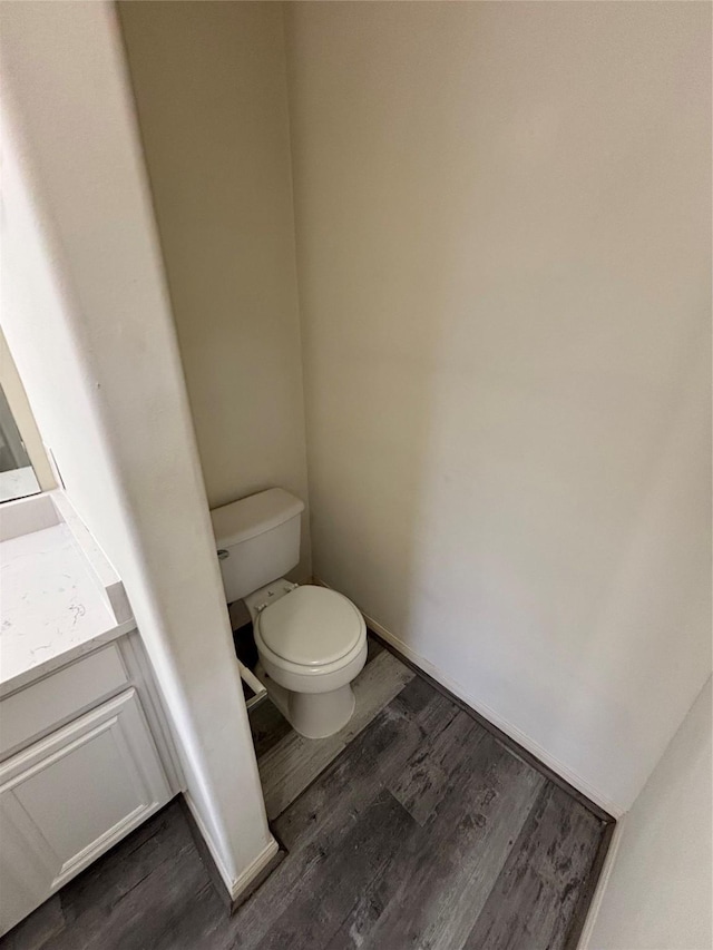 bathroom featuring hardwood / wood-style flooring, vanity, and toilet