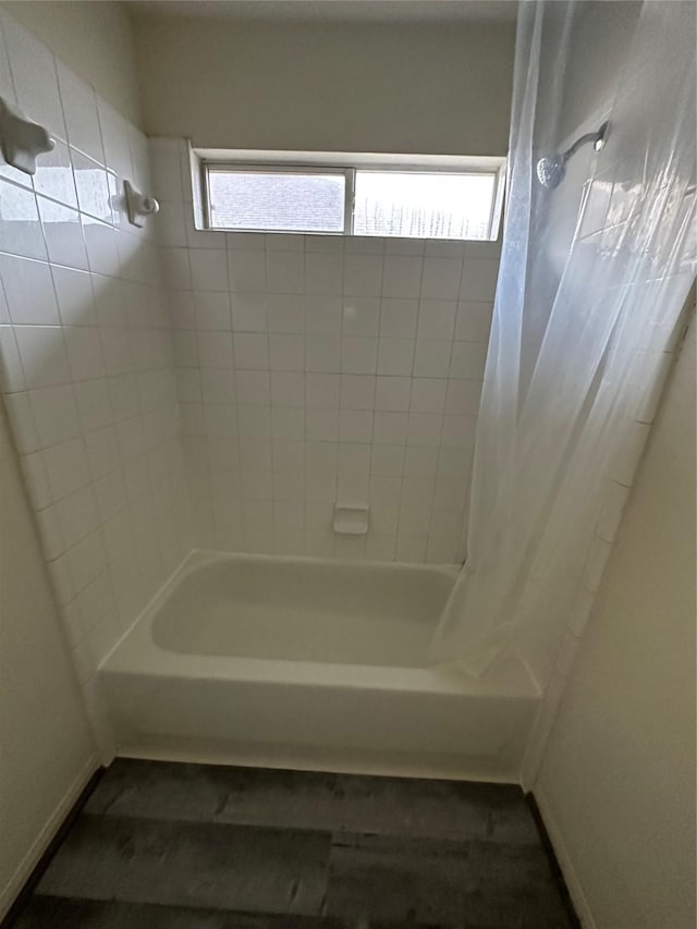 bathroom with shower / bath combo with shower curtain