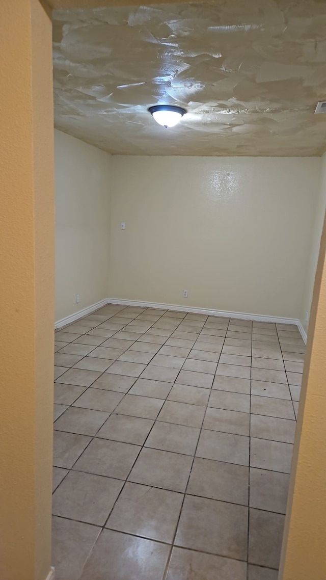 empty room with light tile patterned flooring