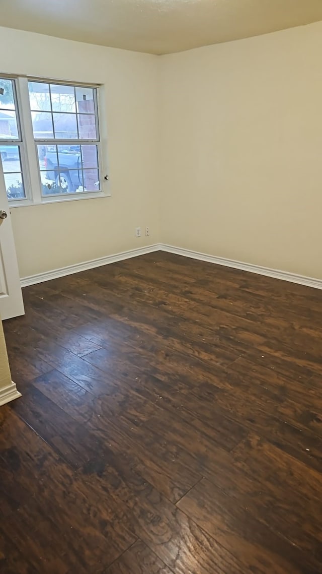 unfurnished room with dark hardwood / wood-style floors