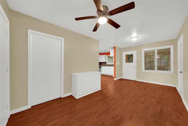 unfurnished living room with wood-type flooring and ceiling fan