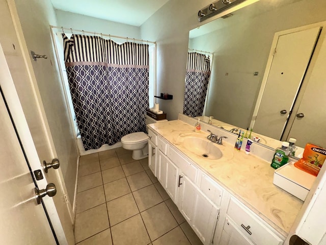 full bathroom featuring vanity, toilet, tile patterned floors, and shower / bath combo with shower curtain