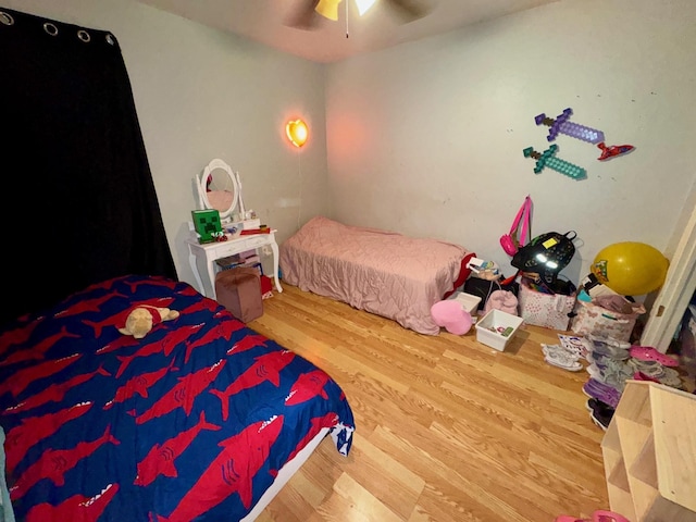 bedroom with ceiling fan and wood-type flooring