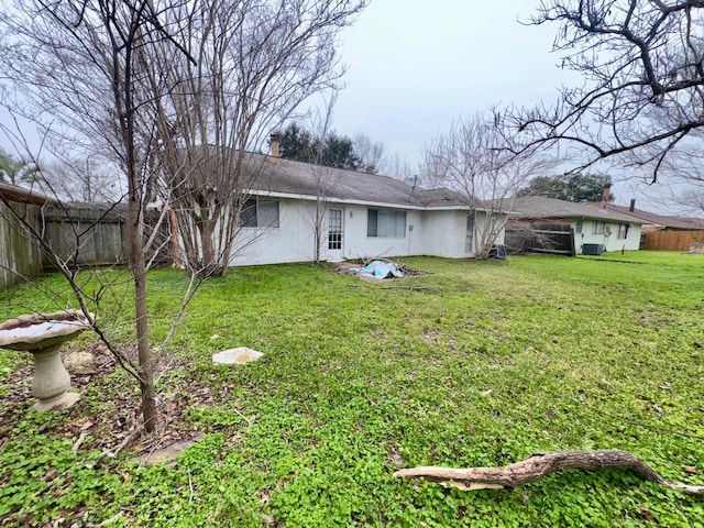 back of property featuring a lawn