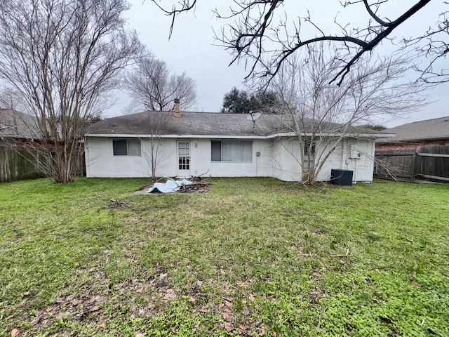 rear view of house featuring a yard