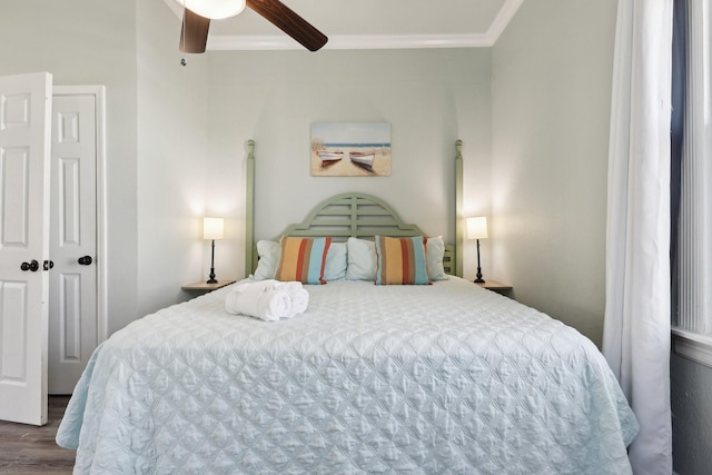 bedroom featuring ceiling fan, ornamental molding, and wood finished floors