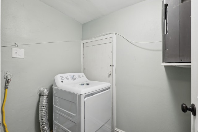 clothes washing area featuring washer / clothes dryer, electric panel, and cabinet space