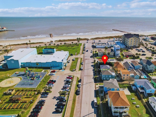 birds eye view of property with a water view and a beach view