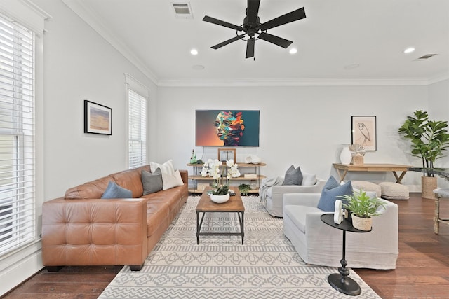 living room with crown molding, wood-type flooring, and ceiling fan