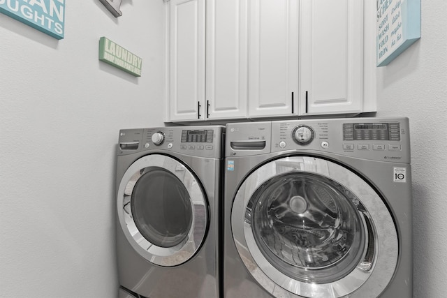 laundry area with cabinets and separate washer and dryer