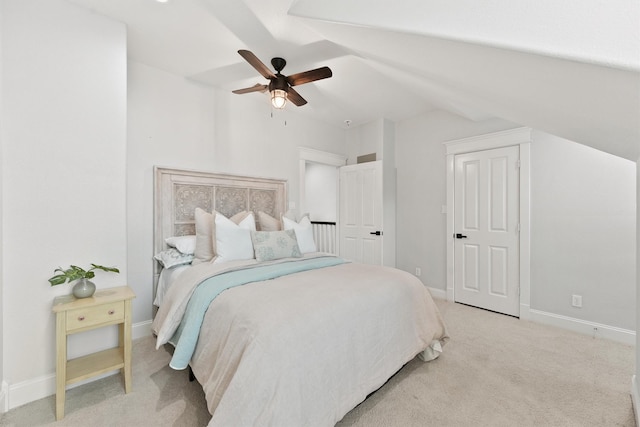 carpeted bedroom with ceiling fan and lofted ceiling