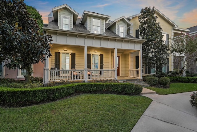 view of front of home with a yard and covered porch