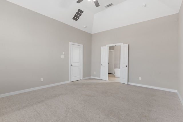 unfurnished room featuring light carpet, visible vents, baseboards, ceiling fan, and high vaulted ceiling