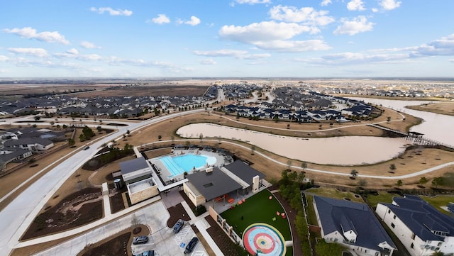 drone / aerial view with a water view and a residential view