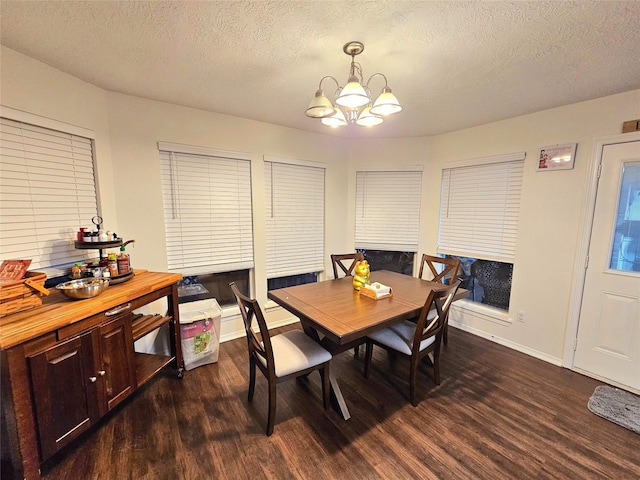 dining room featuring an inviting chandelier, a textured ceiling, and dark hardwood / wood-style flooring