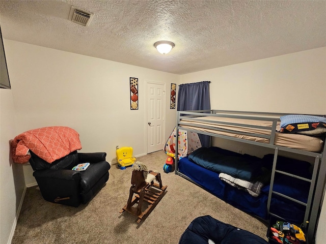 bedroom with carpet flooring and a textured ceiling