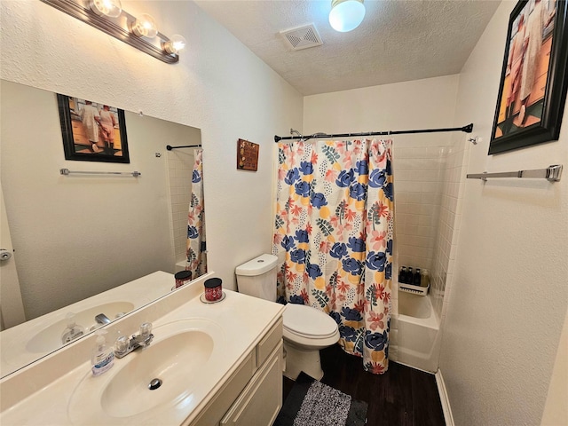 full bathroom with shower / tub combo with curtain, toilet, a textured ceiling, vanity, and hardwood / wood-style flooring