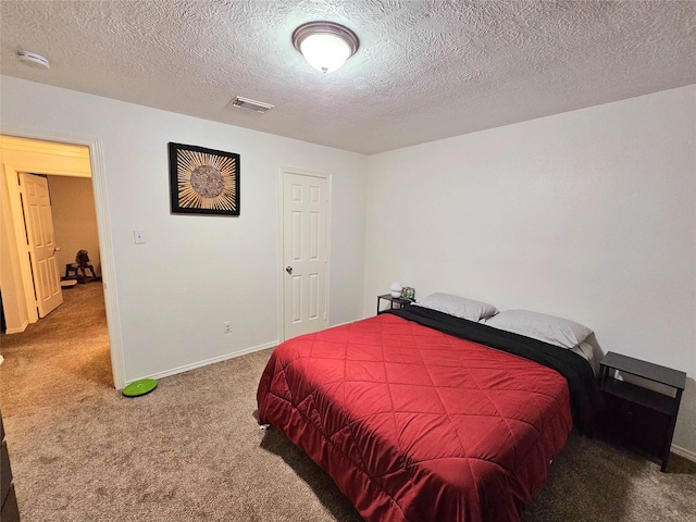 bedroom featuring carpet floors and a textured ceiling