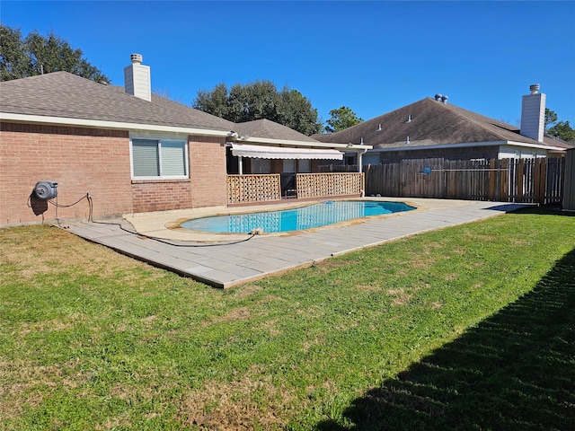 view of pool with a yard and a patio area