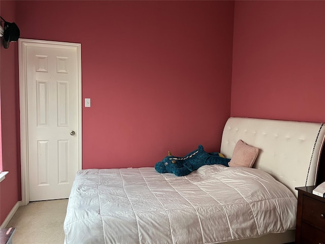 bedroom with light carpet and baseboards