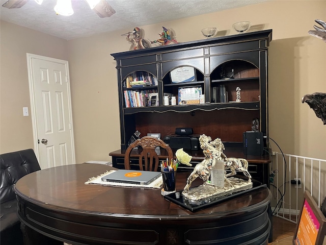 home office featuring a textured ceiling