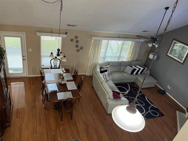 dining area with wood finished floors, visible vents, and baseboards