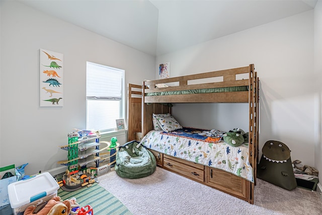 bedroom featuring lofted ceiling and carpet