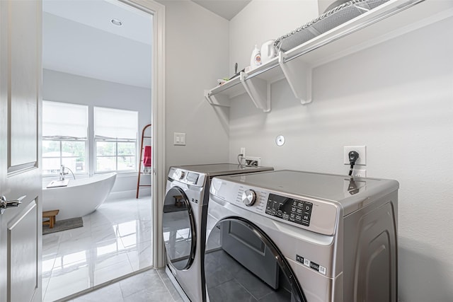 clothes washing area featuring separate washer and dryer