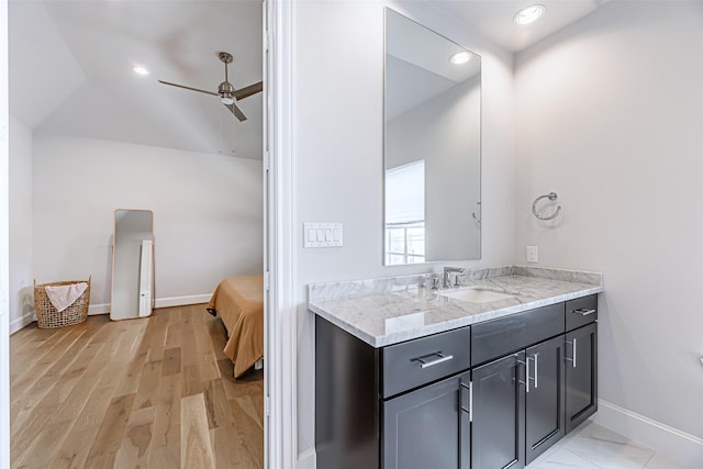 bathroom featuring vanity, wood-type flooring, ceiling fan, and vaulted ceiling