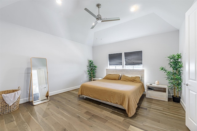 bedroom with ceiling fan, high vaulted ceiling, and hardwood / wood-style floors