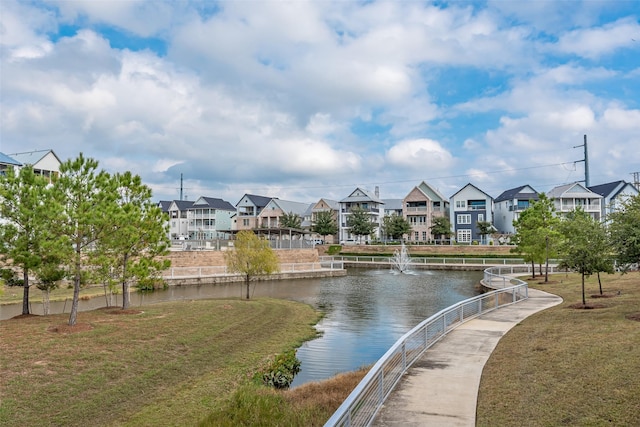 view of home's community featuring a yard and a water view