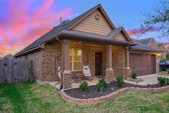 view of front of house featuring a yard and a garage