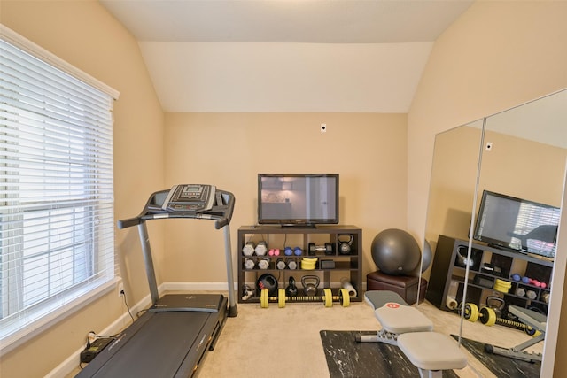workout area featuring carpet flooring and vaulted ceiling