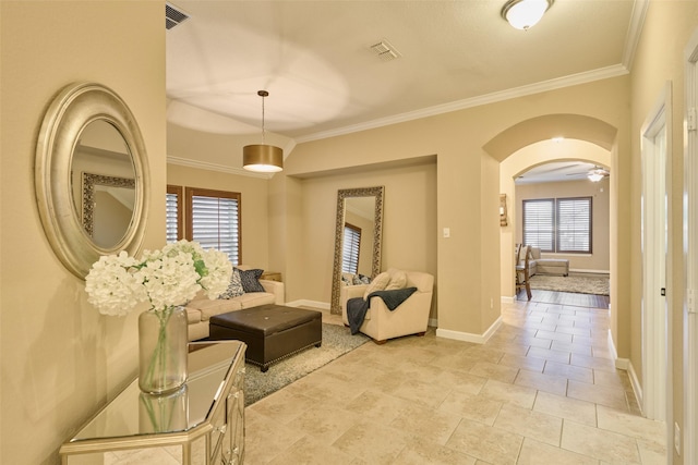 tiled living room with ornamental molding and a wealth of natural light