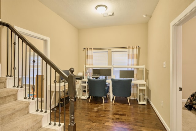 office area with dark hardwood / wood-style flooring and a textured ceiling