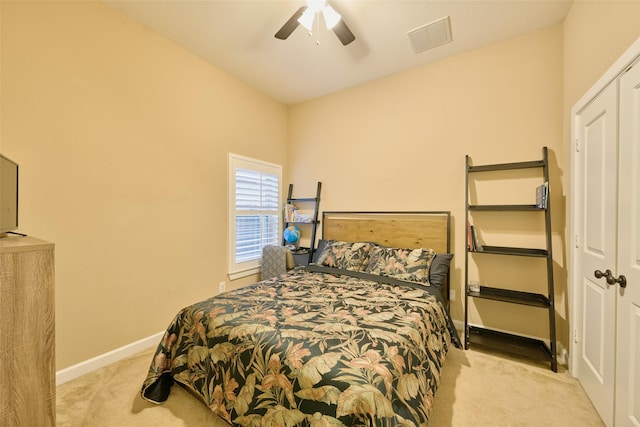 bedroom with light colored carpet and ceiling fan