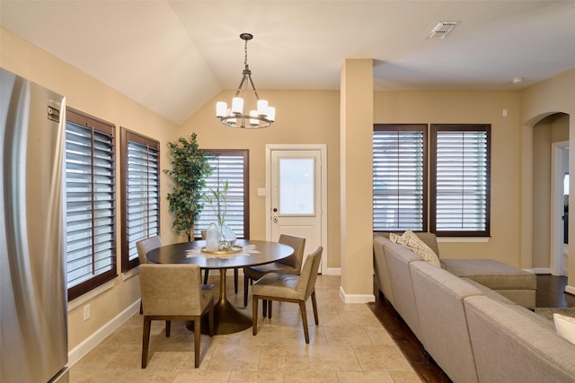 dining room featuring vaulted ceiling and a notable chandelier