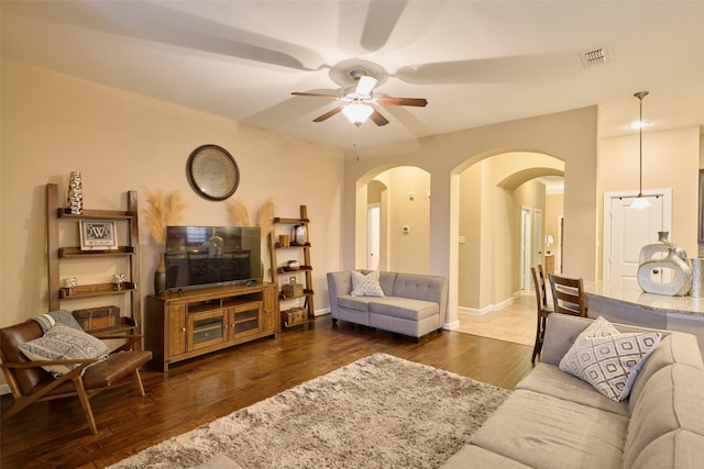 living room featuring dark hardwood / wood-style floors and ceiling fan